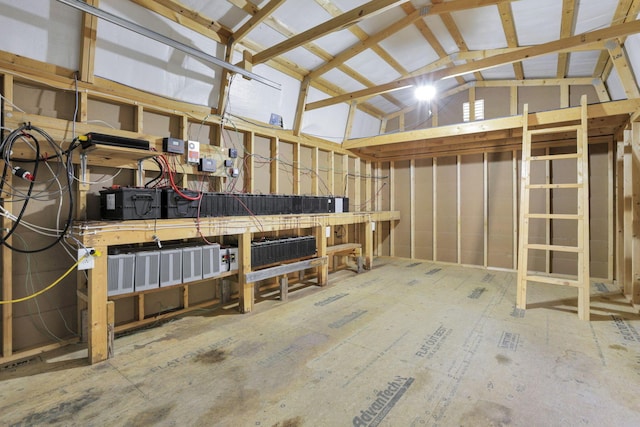 interior space with a workshop area and vaulted ceiling