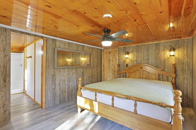 bedroom with light hardwood / wood-style flooring, ceiling fan, wooden ceiling, and wood walls