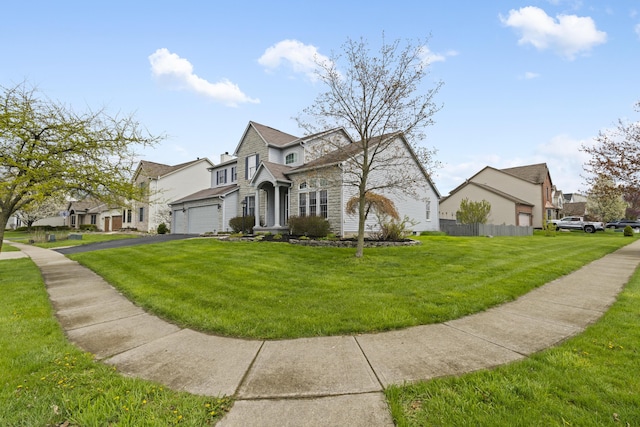 view of side of property with aphalt driveway, an attached garage, a lawn, and a residential view