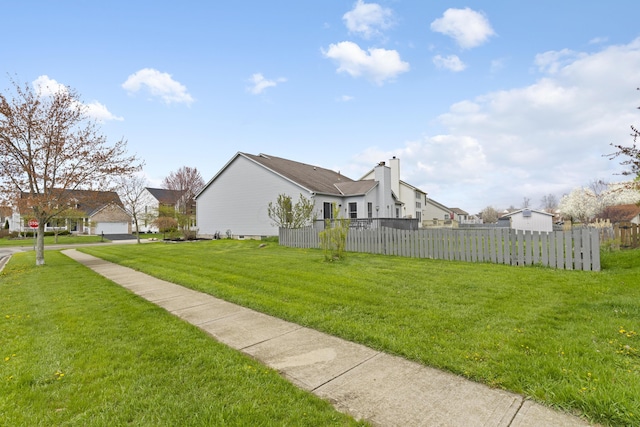 view of yard with a residential view and fence