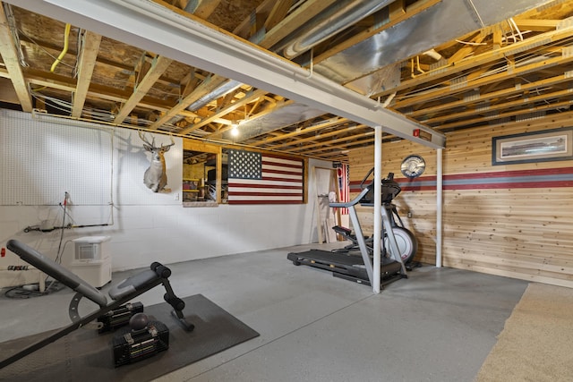 workout area with wood walls and concrete block wall