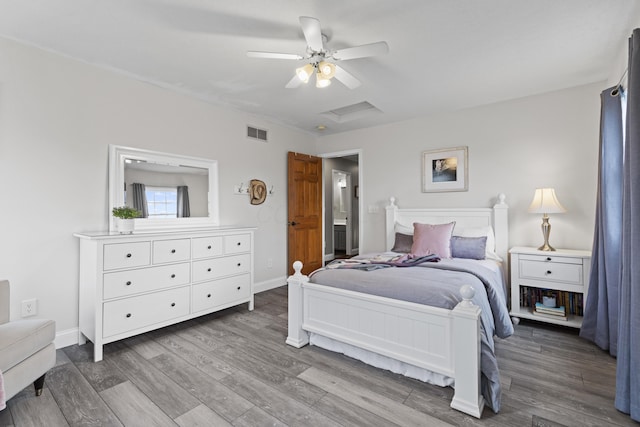 bedroom with visible vents, baseboards, a ceiling fan, and wood finished floors