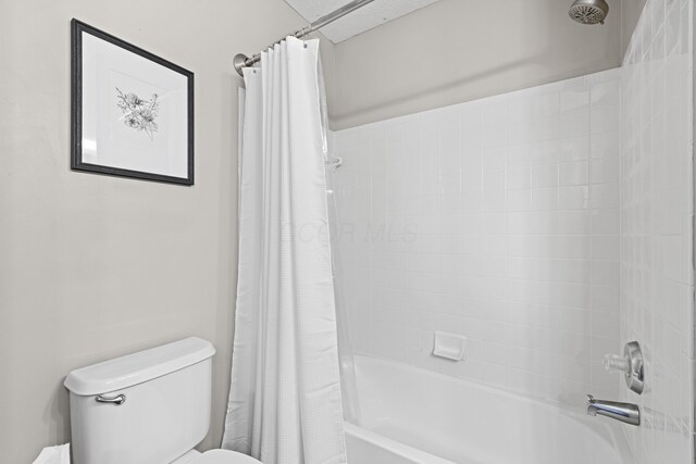 full bath with toilet and shower / bath combination with curtain