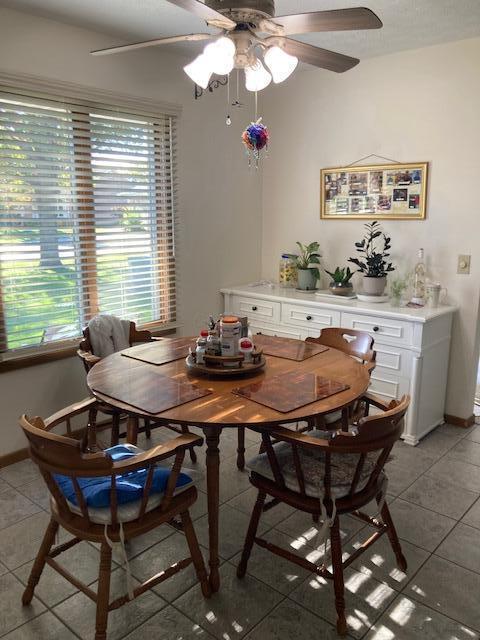 dining space featuring tile patterned flooring and ceiling fan