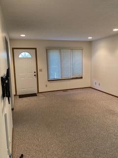 view of carpeted foyer