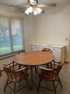 tiled dining area with ceiling fan