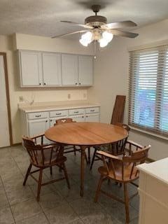 tiled dining room with ceiling fan