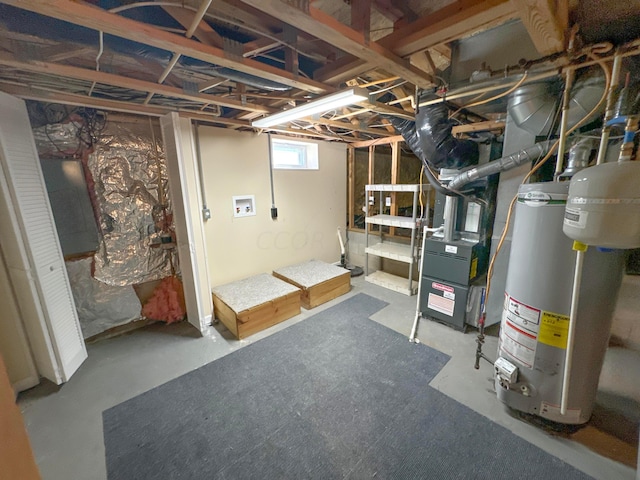 basement featuring gas water heater and heating unit