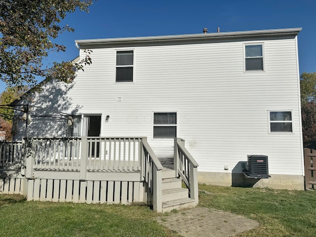 back of house with a lawn, a wooden deck, and cooling unit