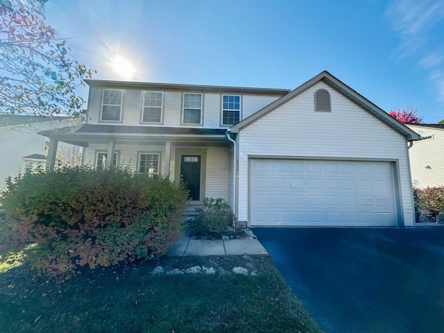 front of property with covered porch and a garage