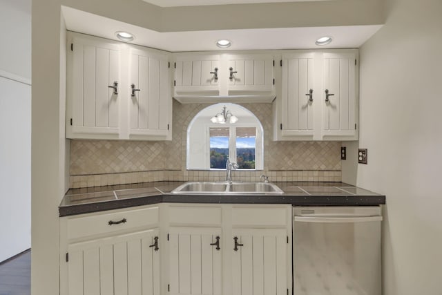 kitchen featuring dark wood-type flooring, sink, stainless steel dishwasher, decorative backsplash, and white cabinetry