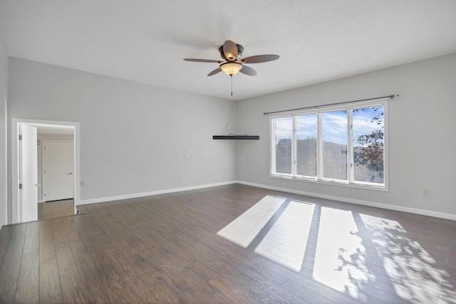 unfurnished room with dark hardwood / wood-style floors and ceiling fan