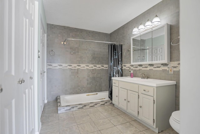 bathroom with tile patterned flooring, vanity, tile walls, and curtained shower