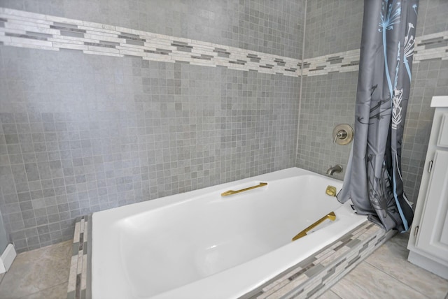 bathroom featuring tile patterned floors, shower / bath combination with curtain, and tile walls