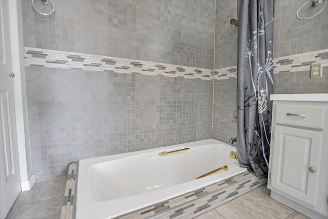 bathroom with tile patterned floors, tile walls, and shower / bath combo with shower curtain