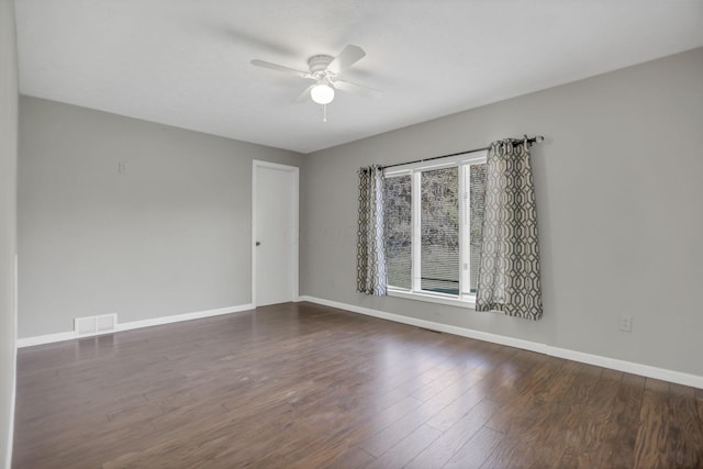 unfurnished room featuring ceiling fan and dark hardwood / wood-style floors