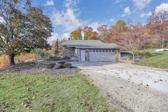 view of side of property featuring a garage and a lawn