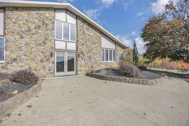 rear view of house with a patio area and french doors