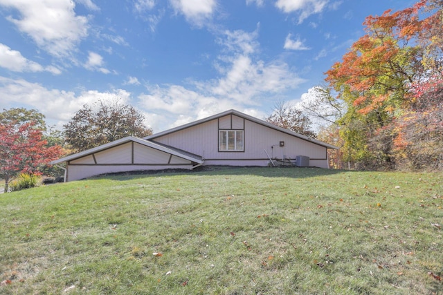 view of front of home with central AC and a front yard