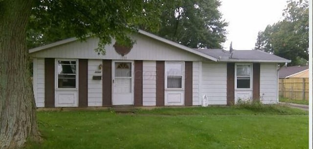 back of property featuring a lawn