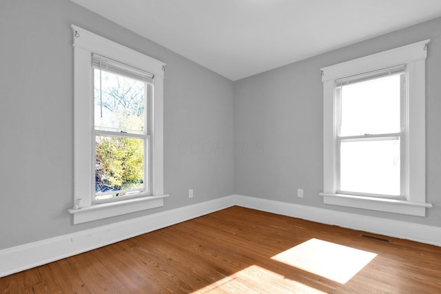 unfurnished room with wood-type flooring