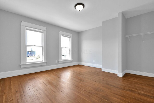 spare room with dark wood-type flooring