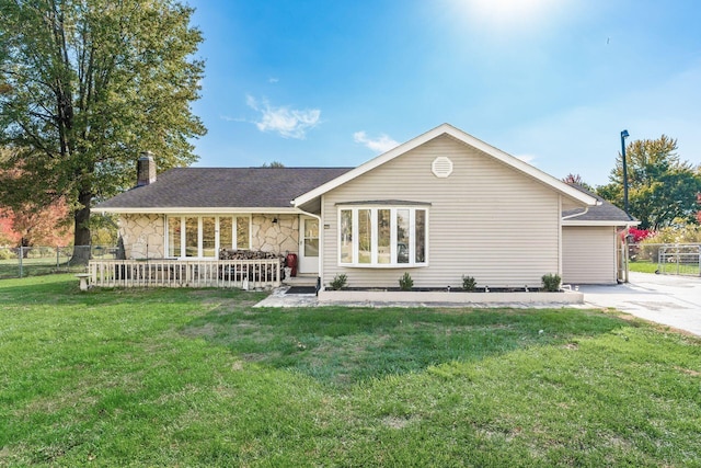 rear view of property with a yard