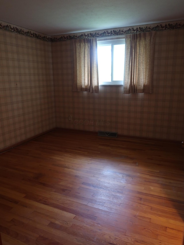 unfurnished room featuring dark hardwood / wood-style floors