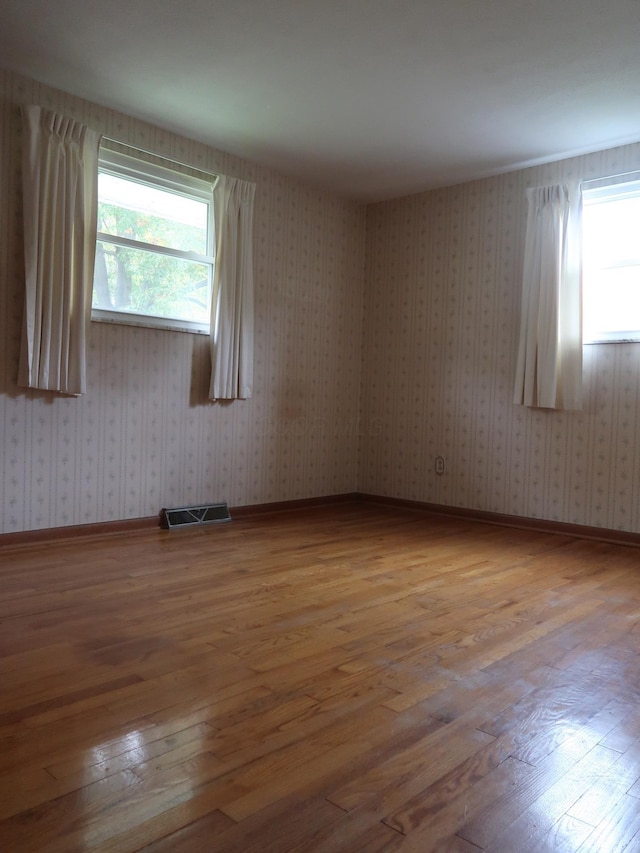 unfurnished room featuring hardwood / wood-style flooring