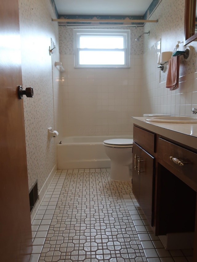 full bathroom featuring vanity, toilet, and tiled shower / bath combo