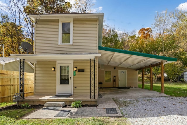 view of front of property with a porch and a carport