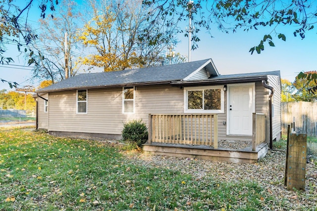 rear view of property featuring a yard