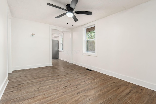 empty room featuring ceiling fan and wood-type flooring