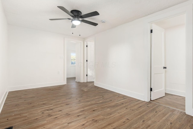 spare room featuring hardwood / wood-style floors, ceiling fan, and a textured ceiling