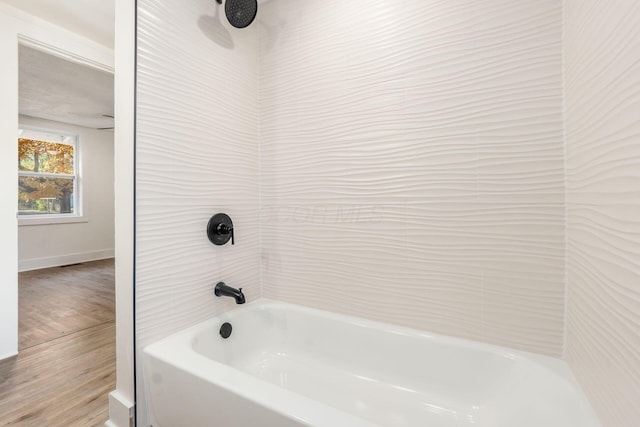 bathroom featuring hardwood / wood-style floors and bathtub / shower combination