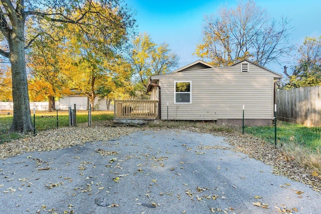 view of property exterior with a wooden deck