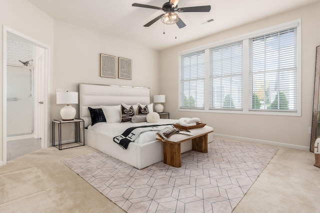 carpeted bedroom with ceiling fan and multiple windows