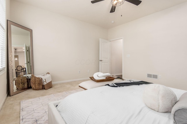 bedroom with light colored carpet and ceiling fan