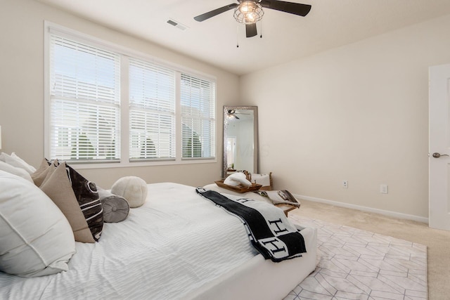 bedroom with light carpet and ceiling fan