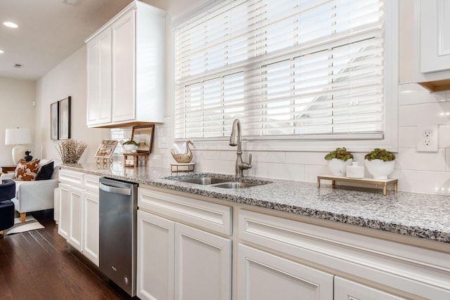 kitchen featuring light stone countertops, dark wood-type flooring, sink, dishwasher, and white cabinetry