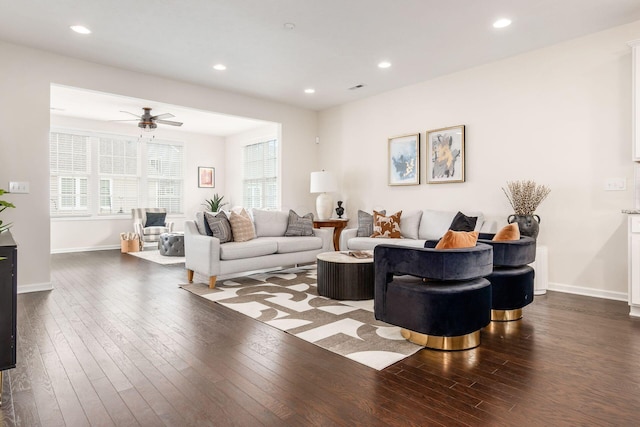 living room with ceiling fan and dark hardwood / wood-style flooring