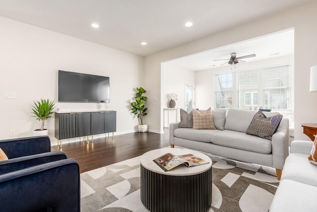 living room featuring ceiling fan and light hardwood / wood-style floors