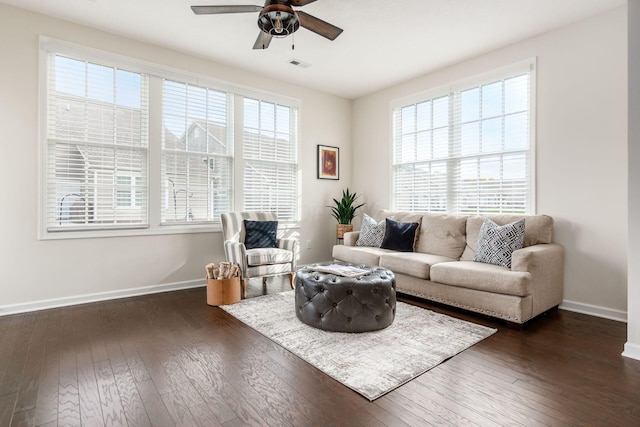 living room featuring ceiling fan and dark wood-type flooring