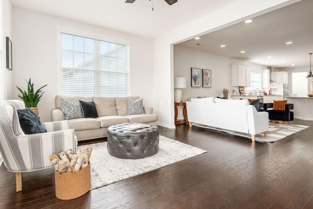 living room with dark hardwood / wood-style floors and ceiling fan