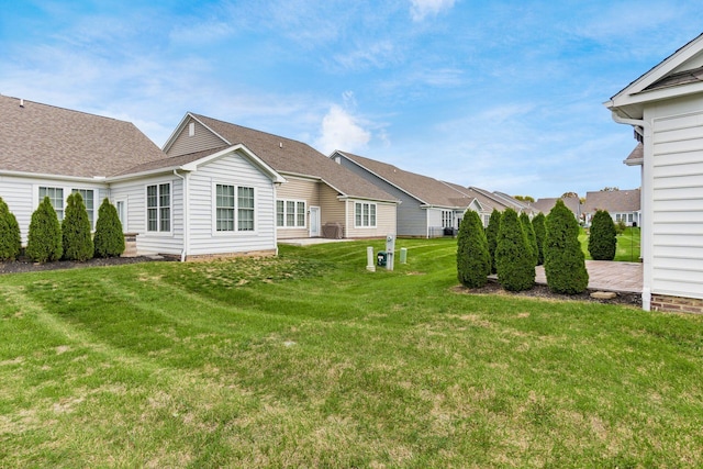 rear view of house featuring a yard