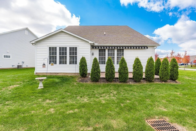 rear view of house featuring a yard