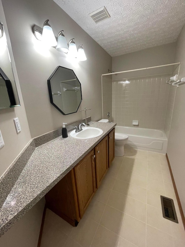 full bathroom with tile patterned floors, a textured ceiling, vanity, toilet, and tiled shower / bath