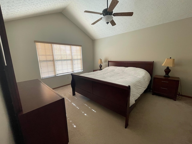 bedroom with a textured ceiling, ceiling fan, lofted ceiling, and light carpet