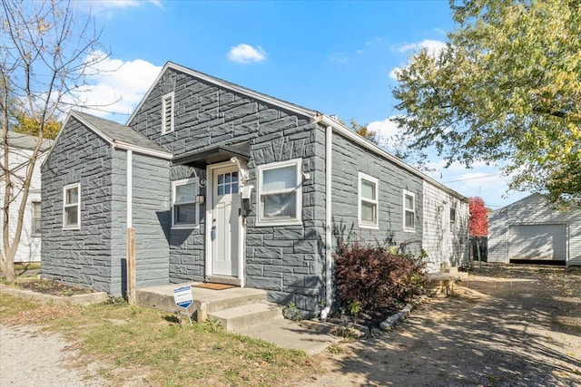 view of front of home featuring an outbuilding