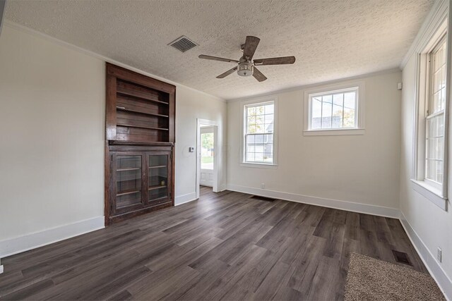 unfurnished living room featuring dark hardwood / wood-style floors, ceiling fan, and a textured ceiling